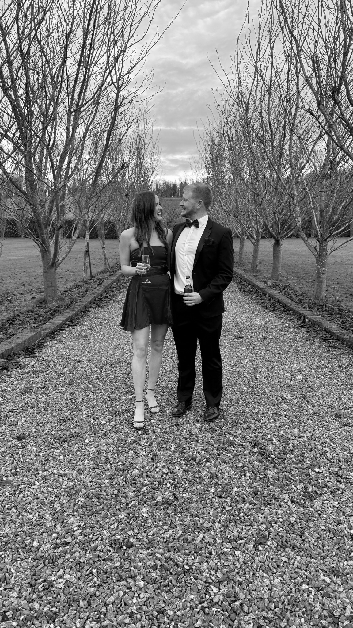 Alex and Stevie together beneath a tree-lined avenue